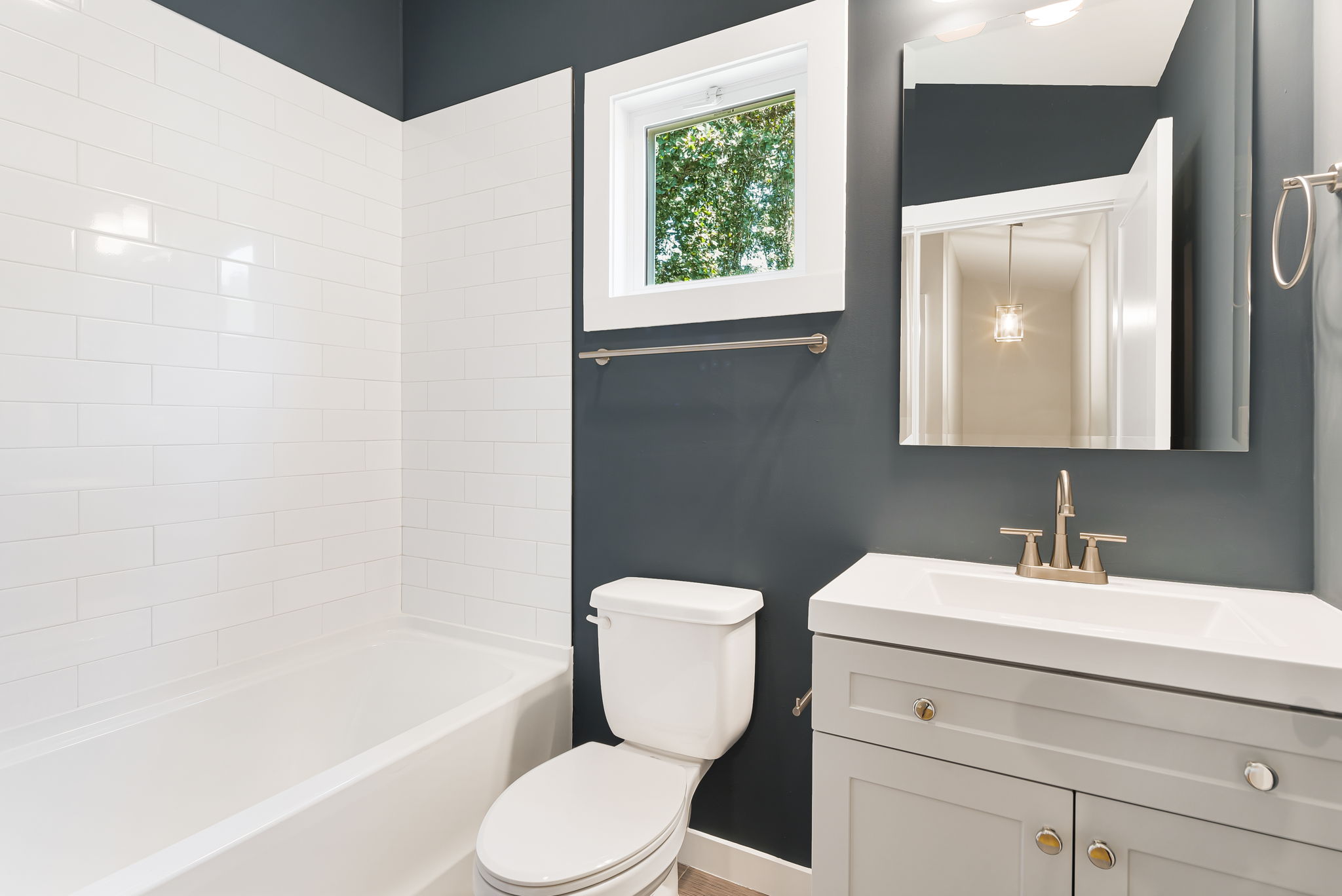 Budget Cottage 2 Bed — bathroom with subway tile and vanity