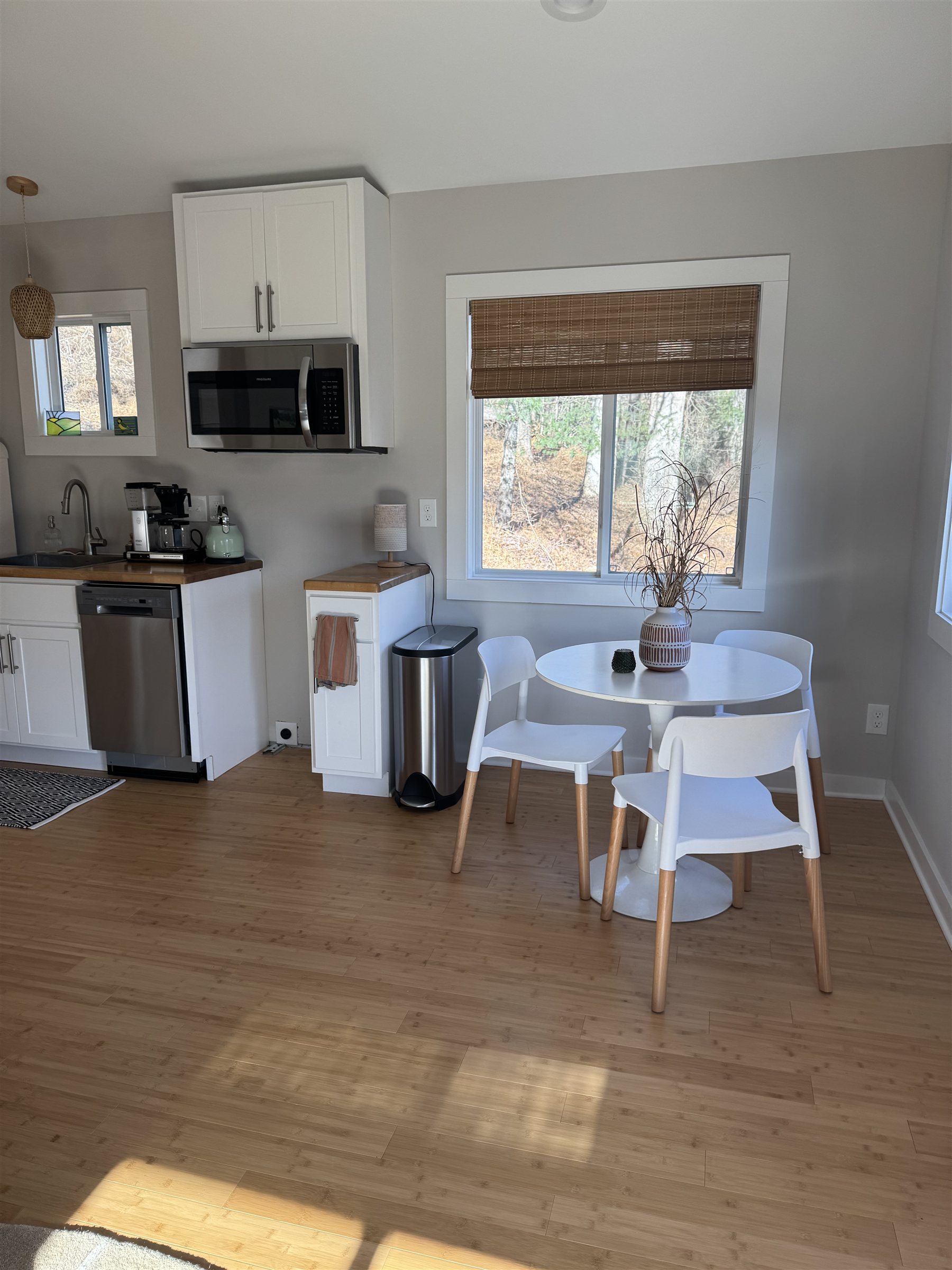 Escape Pod — kitchen with white cabinets and dining nook