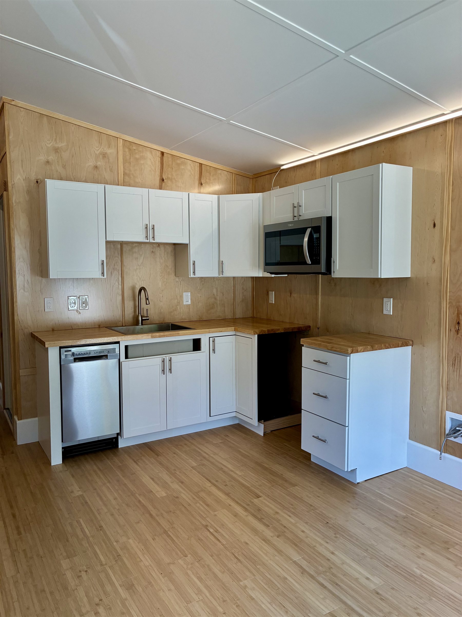 Origami Home kitchen — full L-shaped layout with butcher-block counters