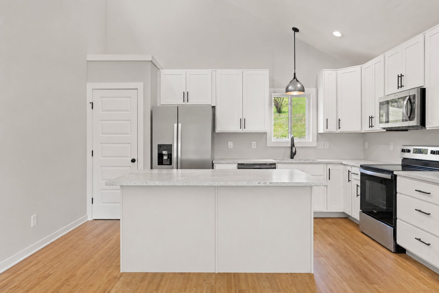 Single Level Cottage 2 Bed — kitchen with white cabinets and stainless appliances