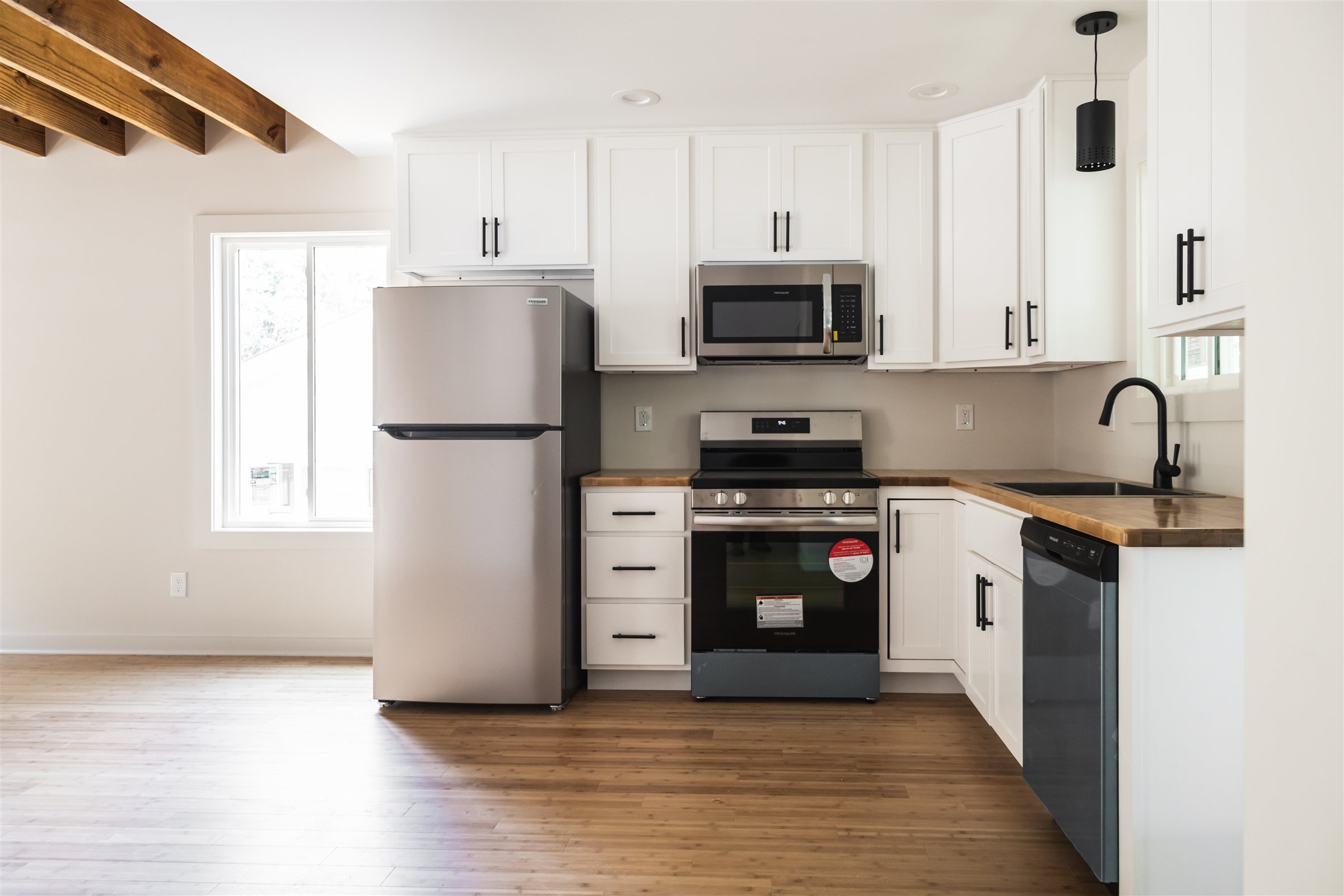 Standard Cottage 3 Bed — kitchen with white cabinets and butcher-block counters